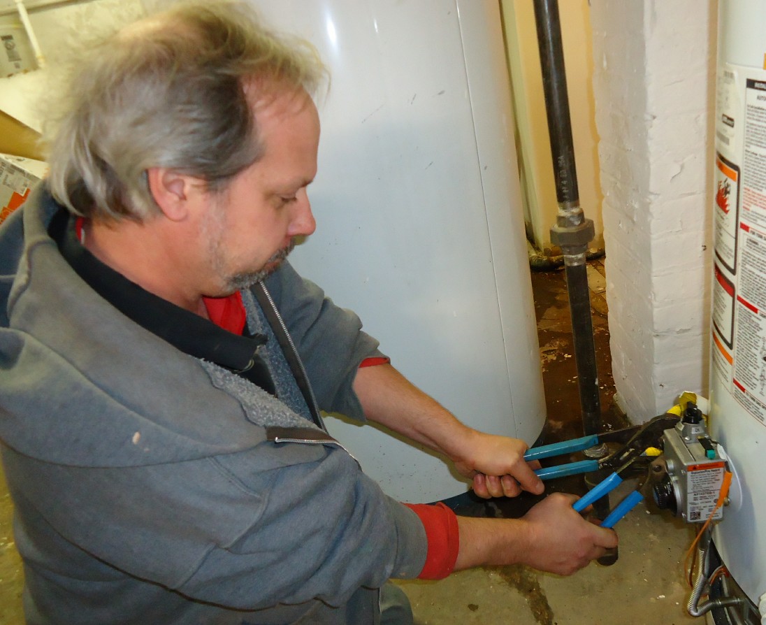 A plumber tightening a fitting on site